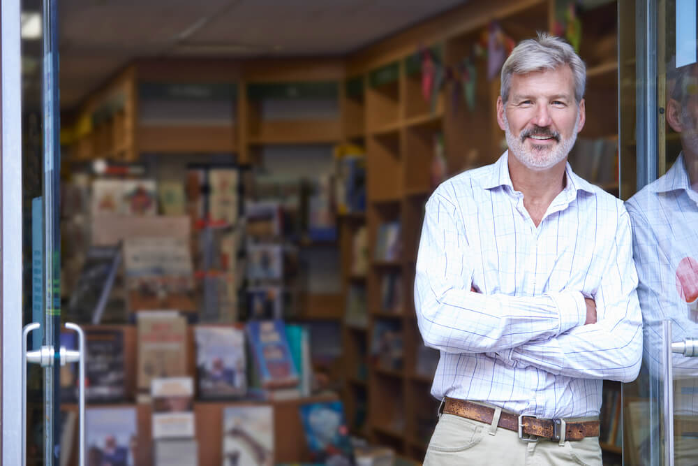 Man leading on wall outside of bookstore